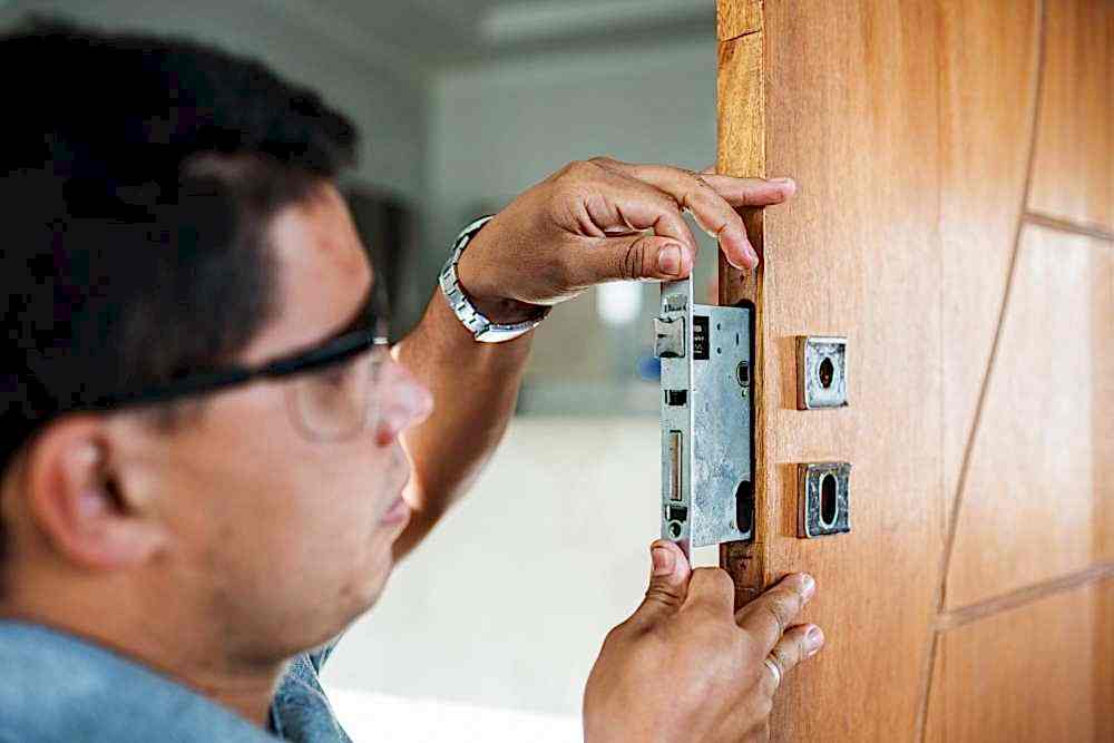 Male that is installing a lock